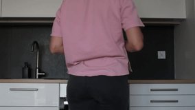 Cleaner woman presenting colorful eco-cleaning sprays and microfiber cloths. Modern white kitchen interior. The concept of delegating routine household cleaning - Powered by Shutterstock - Get 15% off with code: PIKWIZARD15