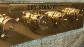 Closeup of rusty standpipe valve assembly, Urban wall with aged plumbing equipment and textured surfaces, Surface details of weathered brass fittings mounted on rough stone in urban stairwell - Powered by Shutterstock - Get 15% off with code: PIKWIZARD15