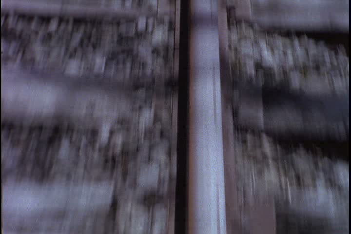 Railway in Hanson, Massachusetts. POV shot of single rail of railroad tracks as train accelerates forward. 