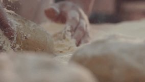 Closeup view of baker’s hands kneading fresh dough on a floured table, showing the beautiful rhythm of daily baking traditions and artisanal breadmaking craft. - Powered by Shutterstock - Get 15% off with code: PIKWIZARD15