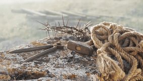 Close-up of a symbolic Jesus crown of thorns with nails, hammer, pliers, and rope on stone, representing crucifixion, faith, and Christianity. - Powered by Shutterstock - Get 15% off with code: PIKWIZARD15