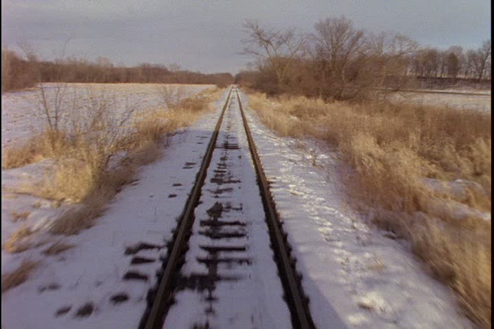 POV shot of snowy train tracks as 1885 steam train accelerates forward on Mid Continent Railway, New Freedom, Wisconsin.