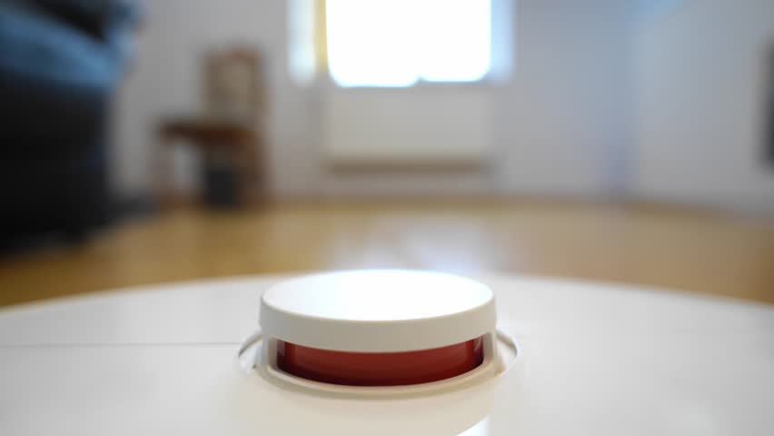 Close-up view of a smart robot vacuum cleaner with its top sensor module inside a modern home interior. Minimalistic household technology concept showing automated cleaning, smart home devices and con
