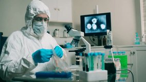 "Laboratory technician handling a coronavirus sample, showcasing virus research, healthcare safety, and scientific testing in a lab environment." - Powered by Shutterstock - Get 15% off with code: PIKWIZARD15