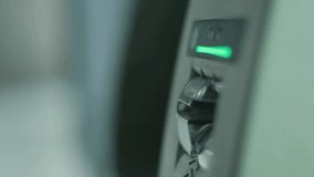 Close-up of a man inserting a credit card into an ATM at the airport, highlighting banking, financial transactions, travel, and digital payment systems. - Powered by Shutterstock - Get 15% off with code: PIKWIZARD15