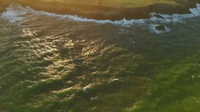Aerial Sunset View of Greenish Ocean Waves Crashing on Cliff Shore With Goats at Playa de Moniello, Asturias, Spain - Powered by Shutterstock - Get 15% off with code: PIKWIZARD15
