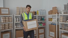 Man pushes box while carrying supplies across warehouse with young hispanic volunteer organizing donations and a guy checking numbers on computer. - Powered by Shutterstock - Get 15% off with code: PIKWIZARD15