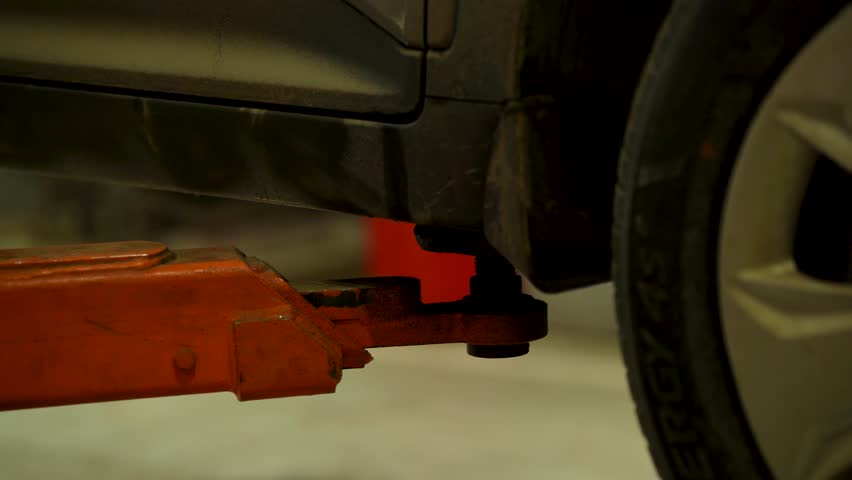 An automatic lift lowers a car at a service center
