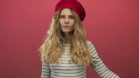 Woman hand covering studio image shows a blonde young woman in beret and striped top with smiling eyes. - Powered by Shutterstock - Get 15% off with code: PIKWIZARD15