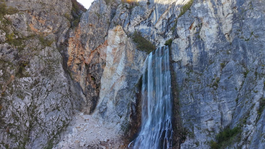 The majestic Boka waterfall cascades down a steep mountain cliff in the Julian Alps of Slovenia
