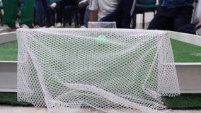 Small robots playing soccer with a ball on a field during a technology and artificial intelligence event at a convention center in Neiva, Huila, Colombia. Concept of technology and innovation - Powered by Shutterstock - Get 15% off with code: PIKWIZARD15