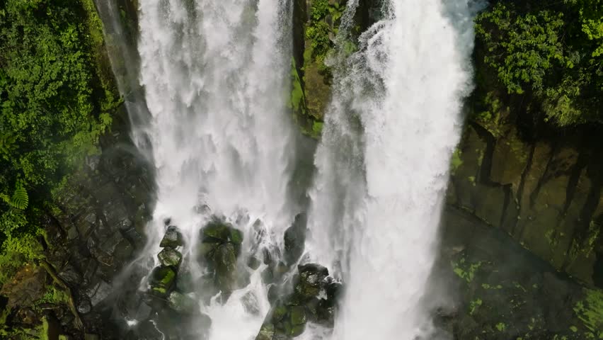 Drone view of water cascade of waterfall in the Philippines. Limunsudan Falls. Mindanao. Slow motion.