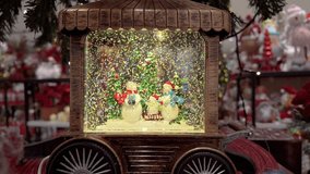 A charming vintage wooden train case hosts a glittering snow globe scene with cheerful snowmen. - Powered by Shutterstock - Get 15% off with code: PIKWIZARD15