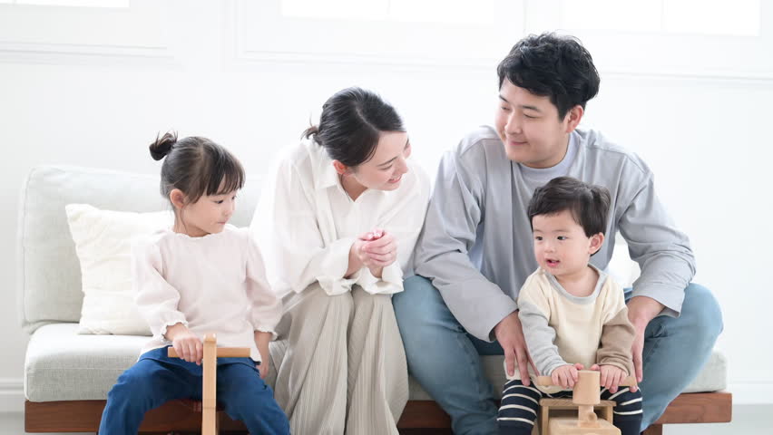 Daily Parenting Life of a Close-Knit Family Video of Caring for Children in the Living Room Watching Over Children's Growth	
