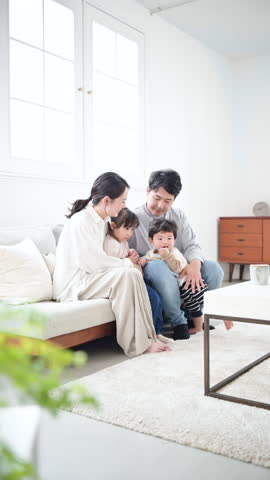 Daily Parenting Life of a Close-Knit Family Video of Caring for Children in the Living Room Watching Over Children's Growth	