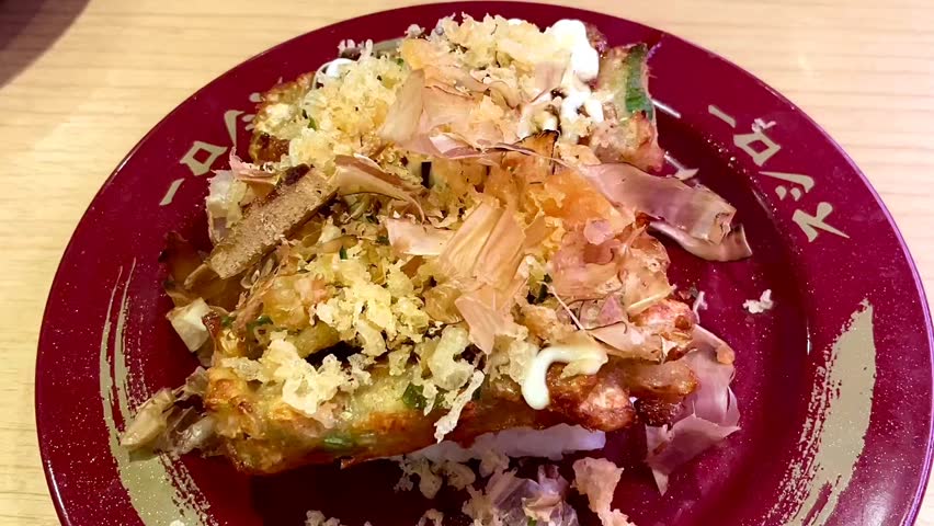 Jakarta, Indonesia - November 17, 2025: Sushi with crispy tuna topping served on a red plate