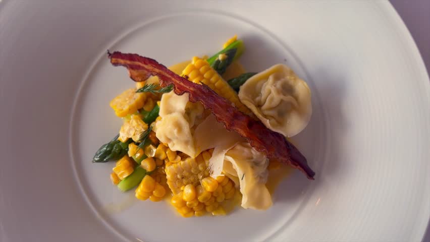 Savor the delicate flavors of prawn tortellini, filled with succulent prawns and served with sweet corn and tender asparagus. This dish combines handcrafted pasta with fresh, seasonal vegetables.