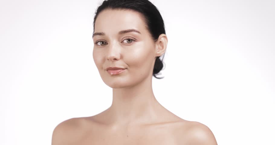 Trendy beauty model applies skincare cream with glowing skin and refined touch. Ideal for premium cosmetic ads, facial care tutorials, soft focus wellness promos, and product branding.