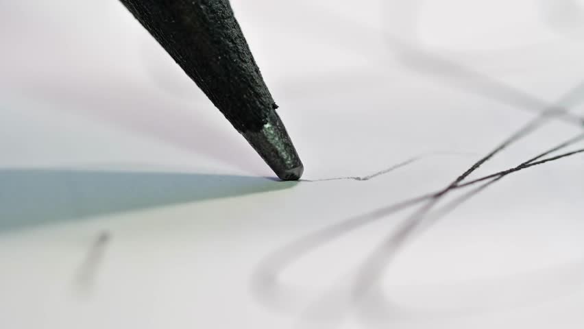 An extreme macro shot showing a pencil tip in motion, emphasizing the texture of the graphite and paper, suggesting intense focus and the start of a creative process