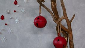 “Red Christmas bell ornament gently swaying on a decorated branch, with a soft-focus holiday wreath and warm lights in the background. A festive and cozy seasonal home décor detail.” - Powered by Shutterstock - Get 15% off with code: PIKWIZARD15