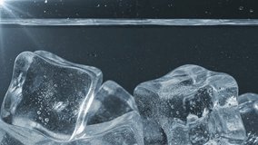 Ice cubes splashing into water with visible bubbles and waves. - Powered by Shutterstock - Get 15% off with code: PIKWIZARD15