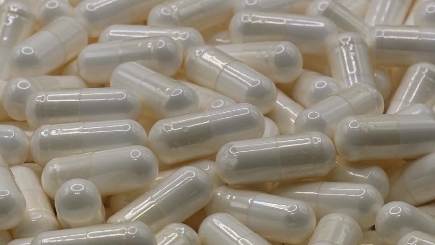 Stack of medicine capsule pills. Pharmacy, medicine and healthcare concepts. Extreme close-up