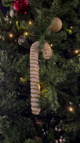 Candy cane and Christmas tree decorations with lights, vertical video.