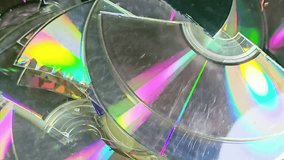 Several broken compact discs CDs that display a rainbow-like effect known as iridescence, a CD is digital optical disc data storage format, to store and play digital audio and video recordings - Powered by Shutterstock - Get 15% off with code: PIKWIZARD15