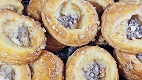 The Danish pastry, a sweet, multilayered, flaky pastry made from a laminated, yeast-leavened dough with a high butter content, soaked with sweet honey syrup, filled with cinnamon, raisin and pineapple - Powered by Shutterstock - Get 15% off with code: PIKWIZARD15