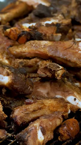 Meat. street food. close-up. grilled meat. Barbecue. fair. food festival. Outdoor cooking. Meat on skewers. Meat on the bone. street market. culinary exhibition or fair.