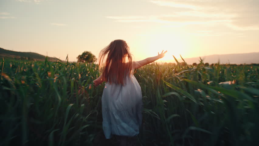 child enjoying freedom running across green meadow in sunset light mindful childhood connection with nature emotional healing happiness and balance cinematic slow motion lifestyle video