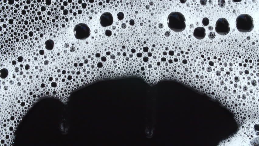 Texture of white soap foam with bubbles abstract background. Soap sud macro structure. Bathtup Soap Foam. Natural White Shampoo Bubbles Motion.