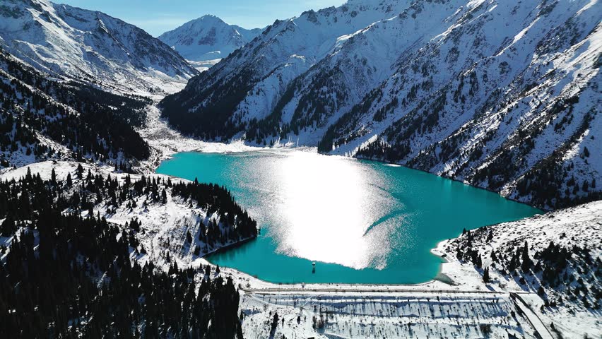 Aerial view of mountain lake at winter with snow
