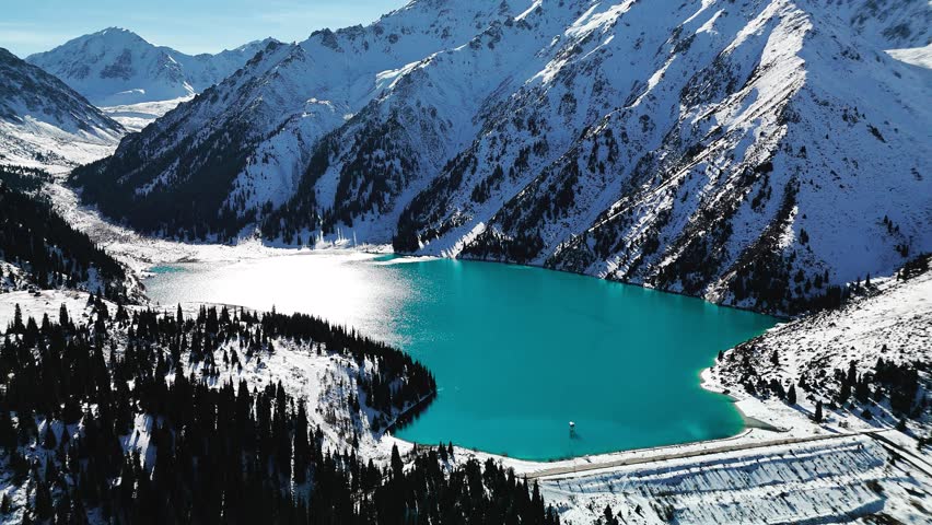 Aerial view of mountain lake at winter with snow