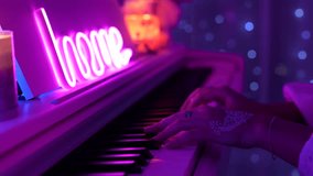 Female hands playing piano under pink neon light with soft bokeh. Cozy home atmosphere, gentle motion, artistic mood and warm ambient glow - Powered by Shutterstock - Get 15% off with code: PIKWIZARD15
