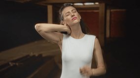 Young woman holding neck with both hands in old building construction site, eyes closed and wincing from neck pain; pain relief. - Powered by Shutterstock - Get 15% off with code: PIKWIZARD15