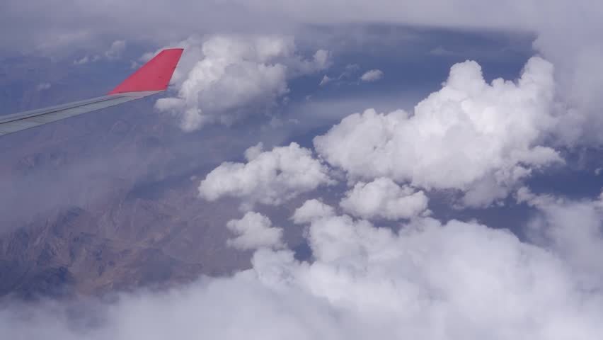 Beautiful view of clouds and passenger plane flying at high altitude, in the daytime sky overcast, cloudscape.