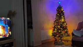 Christmas tree with colorful LED lights glowing in a cozy living room interior - Powered by Shutterstock - Get 15% off with code: PIKWIZARD15