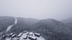FPV glide above a narrow frozen river vanishing under fresh snowfall and winter fog. - Powered by Shutterstock - Get 15% off with code: PIKWIZARD15