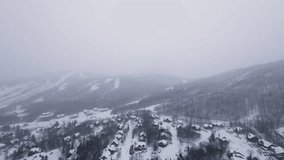 Cinematic FPV flight over snowy alpine hills covered by dense winter snowfall and cold fog. - Powered by Shutterstock - Get 15% off with code: PIKWIZARD15