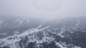 FPV flight above a narrow winter road winding through dense snowy forest during active snowfall. - Powered by Shutterstock - Get 15% off with code: PIKWIZARD15