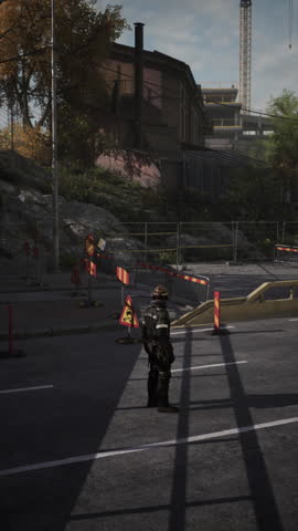 A dedicated road worker stands guard at a busy construction site. Bright barriers and signs mark the area while shadows stretch across the pavement in the warm afternoon sun.