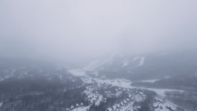 FPV flight over a snowy valley hidden beneath thick mist and snowfall, creating a soft cinematic blend of depth, texture, and winter calm. - Powered by Shutterstock - Get 15% off with code: PIKWIZARD15