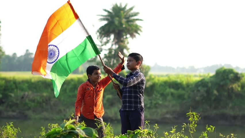 Little boys waving tricolor flag on the occasion of republic day of india.
