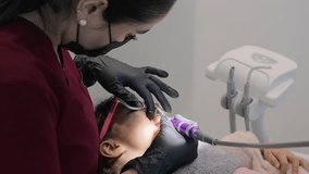 Experienced female dentist providing dental care to a young child patient in a contemporary clinic. The girl is comfortably reclined on the dental chair for treatment - Powered by Shutterstock - Get 15% off with code: PIKWIZARD15