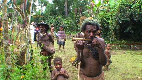 PAPUA NEW GUINEA - NOV.4: Villagers in the Mt. Hagen Highland area in Papua New Guinea, one playing a mouth harp aka juice harp. November 4, 2008. 