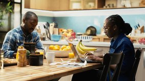 African American partners involved in a heated discussion about money. Surrounded by invoices and calculator, arguing about expenses, reflecting financial strain and relationship tension. Camera B. - Powered by Shutterstock - Get 15% off with code: PIKWIZARD15