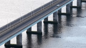 A lone car crosses Tay Road Bridge over calm river water in steady daylight. - Powered by Shutterstock - Get 15% off with code: PIKWIZARD15