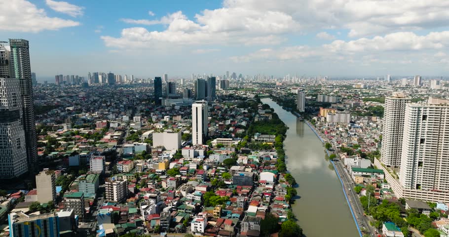 Cityscape: Drone view of modern buildings, hotels, and houses in riverside. Manila, Philippines.