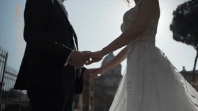 A lovely married couple holds hands in warm sunlight as the elegant bride admires the groom, posing together with the stunning ancient Roman Forum as their backdrop. - Powered by Shutterstock - Get 15% off with code: PIKWIZARD15